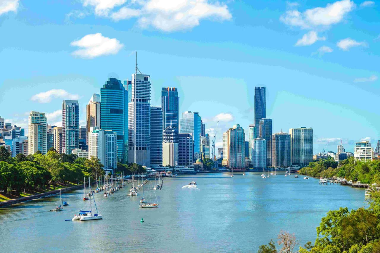 A panoramic view of Brisbane city skyline with modern buildings and the Brisbane River, representing Verlane Media’s location and connection to clients across Queensland.