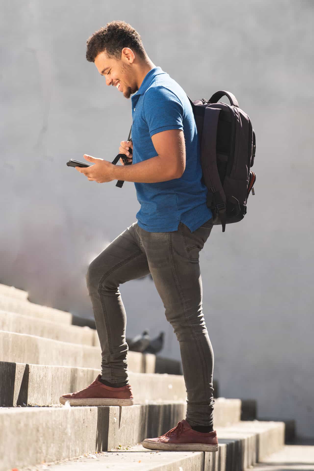 A student with a backpack walking up steps, symbolizing taking the next steps toward application.